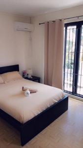 a bedroom with a bed with a stuffed animal on it at Residence Frangipani in Pereybere