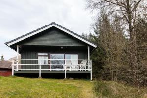 a house with a balcony with two chairs on it at Heron chalet in Crianlarich