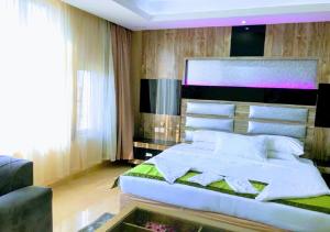 a bedroom with a large white bed and a window at Al- Reef Hotel in Jeddah
