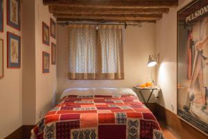 a bedroom with a bed with a checkered blanket at Magazzini del Sale VeniseJeTaime in Venice