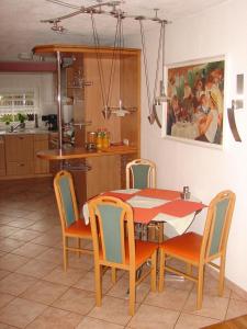a kitchen with a table and chairs and a dining room at Messezimmer Laatzen APO 3 in Hannover