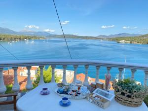 a table on a balcony with a view of the water at Kasteli Suite in Poros