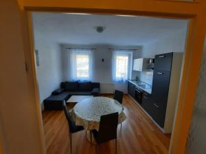 a kitchen and a living room with a table and a couch at Apartment Wildbad in Bad Wildbad
