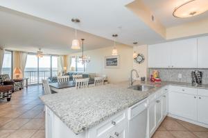 a kitchen and living room with a view of the ocean at 220 Charleston Oceanfront Villas Dolphin View in Folly Beach
