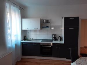 uma cozinha com electrodomésticos pretos e um frigorífico preto em Apartment Wildbad em Bad Wildbad