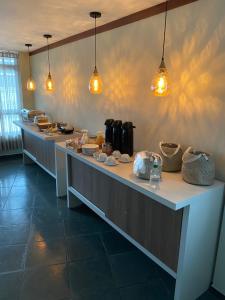a buffet line in a restaurant with lights on the wall at Hotel Onda Azul in Valença