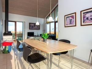 a dining room with a wooden table and chairs at Three-Bedroom Holiday home in Ulfborg 27 in Thorsminde