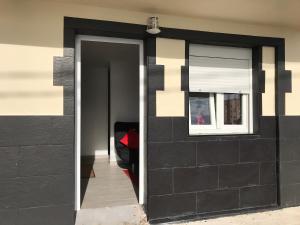 a black door with a window in a house at Studio 1 Hab in Pájara