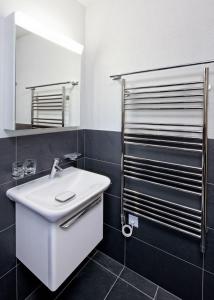 a bathroom with a white sink and a mirror at Ski in Ski out LUXURY & MOUNTAIN apartments by Alpvision Résidences in Veysonnaz