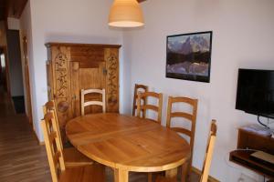 a dining room with a wooden table and chairs at Meinaz QUIET & SUNNY apartments in Veysonnaz