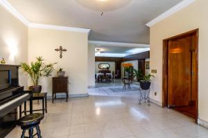 a living room with a piano and a dining room at Casa de Luz in Guadalajara