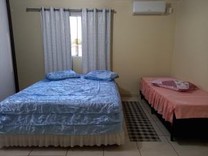 מיטה או מיטות בחדר ב-Sobrado 02 quartos próx. Hotel Recanto Cataratas