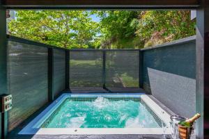 a swimming pool in a house with a window at Lake Terrace Lockwood in Taupo