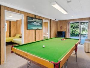 a room with a pool table in a room at Family Fun at The Lake - Lake Tarawera Home in Lake Tarawera