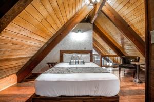a bedroom with a large bed in a attic at Wanderlust Inn in Ocean Shores