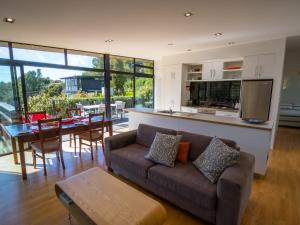 a living room with a couch and a table at Bauhaus - Kaiteriteri Holiday Home in Kaiteriteri