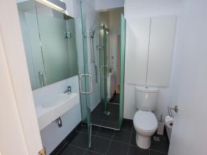 a bathroom with a toilet and a sink and a shower at Bauhaus - Kaiteriteri Holiday Home in Kaiteriteri