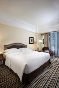 Postel nebo postele na pokoji v ubytování Hotel Gran Mahakam