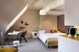 a bedroom with a bed and a desk in a room at Hotel Continental Park in Lucerne