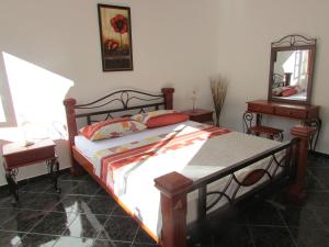 a bedroom with a bed and a dresser and a mirror at Apartments Popovic in Kotor