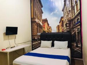 a bed in a room with a view of a city at The One Hotel Gorontalo Mitra RedDoorz in Telaga