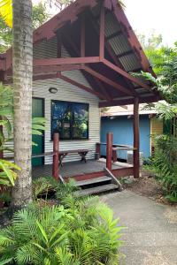 a porch with a bench on a house at Airlie Beach Magnums - Adults Only in Airlie Beach