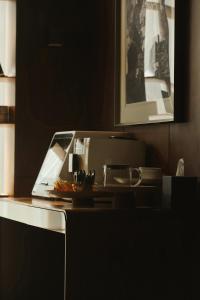 a kitchen counter with a sink and a microwave at The Nook Hotel Hangzhou - A design hotel, Near subway in Hangzhou