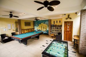 a living room with a pool table and a library at Captain's Lodge and Bar in Panglao