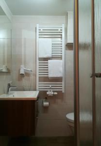 a bathroom with a sink and a toilet and towels at Gasthof Meindl in Arrach