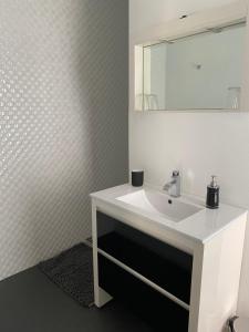 a bathroom with a white sink and a mirror at Chambres d'hôtes CASA COSY in Les Avirons +22 photos