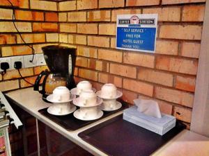 a counter top with a bunch of bowls and a blender at U Design Hotel Temerloh in Temerloh
