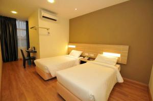 Tempat tidur dalam kamar di U Design Hotel Temerloh