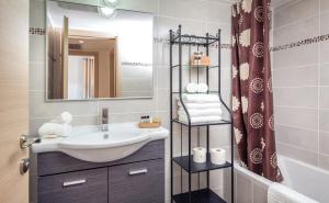 a bathroom with a sink and a mirror at Stay Jaffa Jerusalem in Jerusalem +61 photos