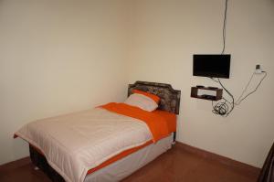 Кровать или кровати в номере QQ Guesthouse