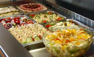 a buffet filled with different types of food in trays at Hotel Srbija-FREE PARKING in Belgrade
