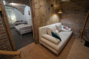 a living room with a couch and a brick wall at Willa Anna in Szklarska Poręba