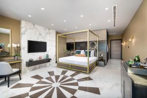 a hotel room with a bed and a television at Lure Hotel & Spa - Adults Only in Mellieħa