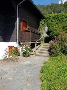 a stairway leading to a house with a porch and flowers at Chalet Brimborion in Champéry