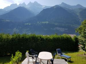 a table and chairs with a view of mountains at Chalet Brimborion in Champéry