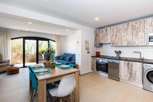 a kitchen and living room with a table and chairs at Beach Pearl Cala de Mijas in Mijas