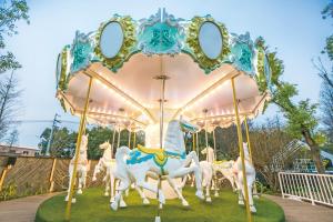 a group of horses on a carousel at a park at Hsin Hotel in Chiayi City