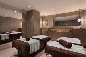a hospital room with two beds and a mirror at Maritim Antonine Hotel & Spa in Mellieħa