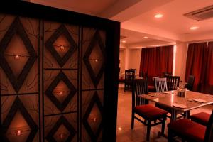 a dining room with a table and a wall at Nagarjuna Suites in Bangalore