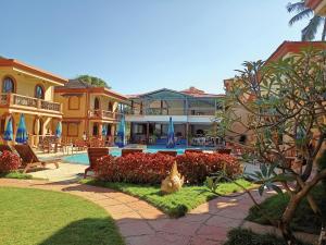 a large white building with a large window at Resort Terra Paraiso in Calangute