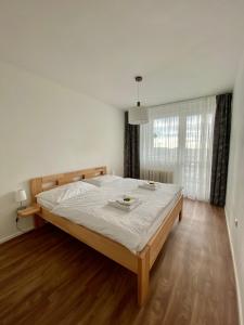 a bedroom with a large bed in a room at Prázdninový dům Holubka in Nové Město na Moravě