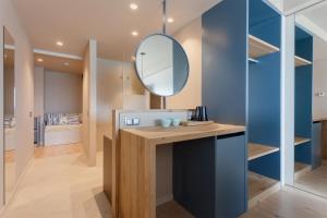 a bathroom with a vanity with a mirror at Hotel Maritim in Roses