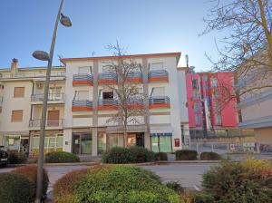 a large building with an american flag on it at Residence Carlo in Grado