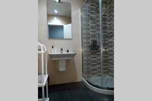 a bathroom with a sink and a glass shower at DISFRUTE DE SUS VACACIONES CON WIFI EN EL PUERTO DE CARIÑo in Cariño +22 photos