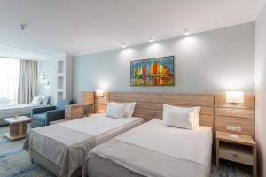 Un pat sau paturi într-o cameră la Hotel Neptun Beach