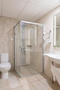 a bathroom with a shower with a toilet and a sink at Hotel Neptun Beach in Sunny Beach